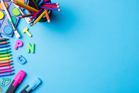 Overhead shot of school supplies on blue backgroundの写真素材