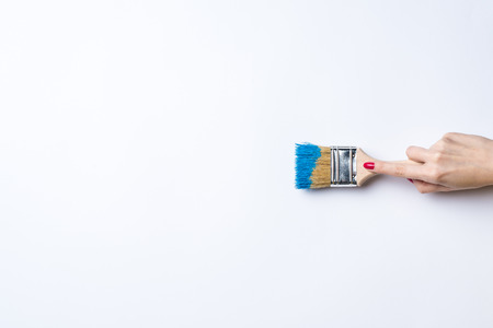 Woman painting empty white wallの写真素材