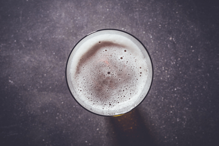 Beer glass on dark tableの写真素材