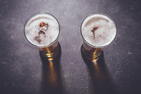 Beer glasses on a dark tableの写真素材