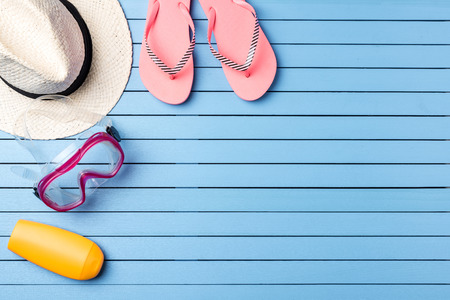 Summer holiday background with beach accessories on blue wooden plankの写真素材