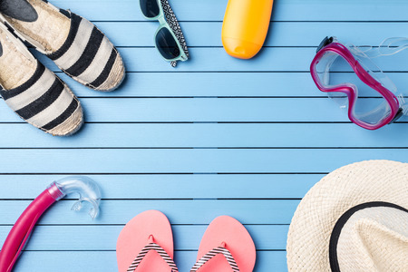 Summer holiday background with beach accessories on blue wooden plankの写真素材