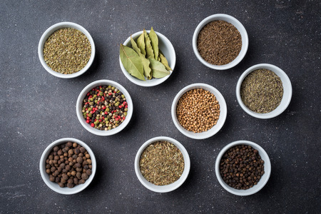Herbs and spices in white bowlsの写真素材