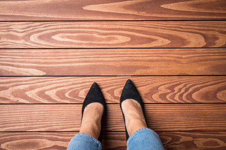 Woman standing on wooden floorの写真素材