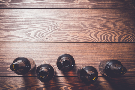 Overhead shot of beer bottles on wooden tableの写真素材