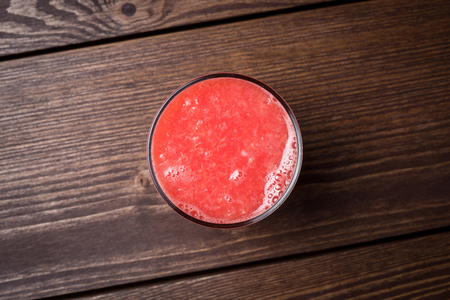 Freshly squeezed grapefruit juice on wooden tableの写真素材