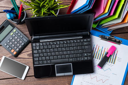 Office desktop with graphs and charts, documents and modern digital devices. Business backgroundの写真素材