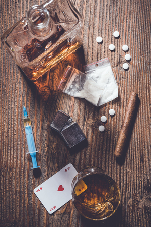 Addiction concept. Hard drugs and alcohol on wooden tableの写真素材