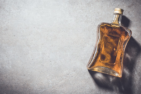 Bottle of whiskey on gray stone tableの写真素材