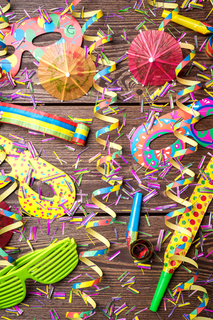 Colorful party background on wooden tableの写真素材