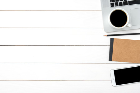 White office desktop with laptop and business accessoriesの写真素材