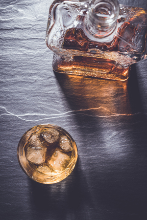 Whiskey glass on dark stone tableの写真素材