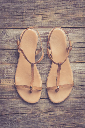 Female shoes on an old wooden tableの写真素材