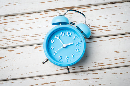 Alarm clock on an old wooden table
