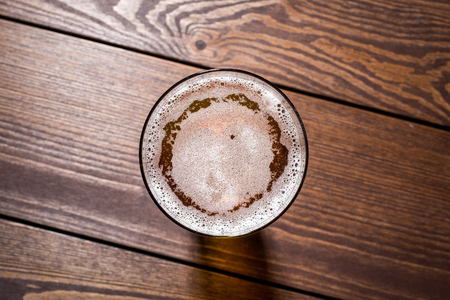 Beer glass on wooden table. Close upの写真素材
