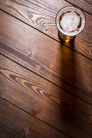 Beer glass on wooden table. Close upの写真素材