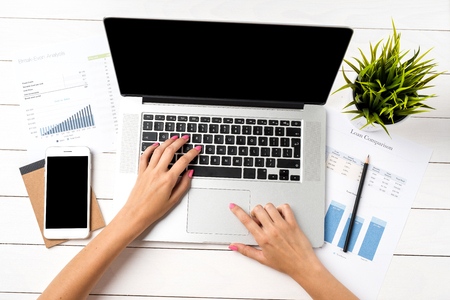 Modern office desktop with business woman hands. Close upの写真素材