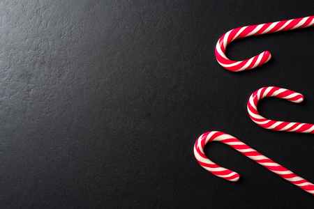 Candy cane over dark backgroundの写真素材