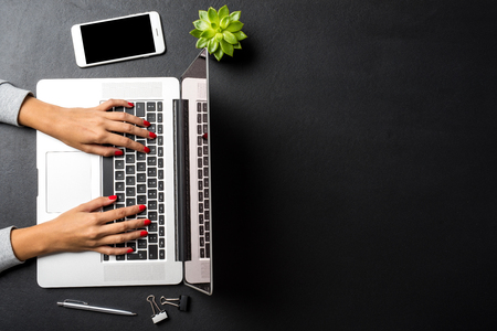 Woman working on laptop. Office background with copyspace.の写真素材