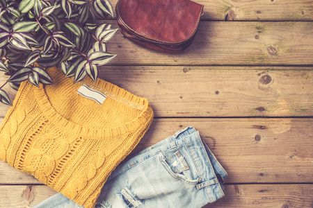 Female winter or autumn outfit over an old wooden backgroundの写真素材