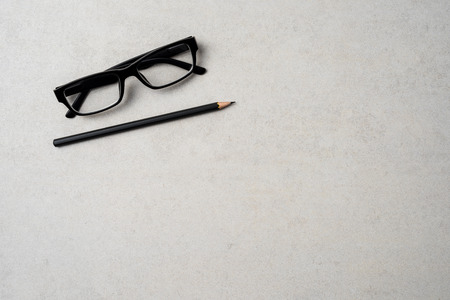 Office desktop with pen and glassesの写真素材