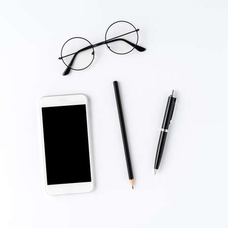 Mobile phone with copyspace and business accessories. Office desktop