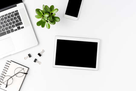 Elegant office desktop with business accessories and digital tablet with empty screen. Modern workplace. Top viewの写真素材