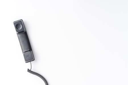 Vintage handset isolated on white desktop with copyspace. Hotline concept