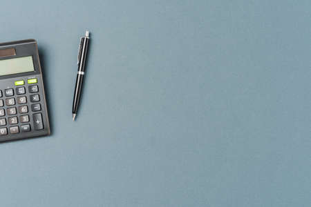 Office desktop with calculator and pen on backgroundの写真素材