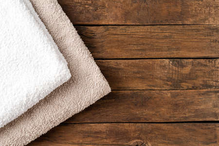 Overhead shot of clean folded towels on rustic wooden table with copyspaceの写真素材