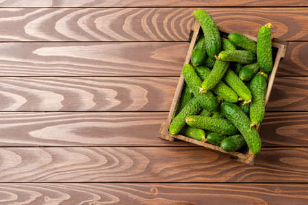 Cucumbers on wooden background with copyspace