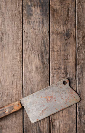 Rustic butcher knife on wooden background