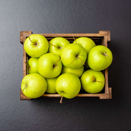 Green apples on black tableの写真素材