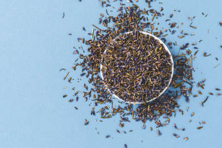 Dried lavender flowers on blue background. Top viewの写真素材