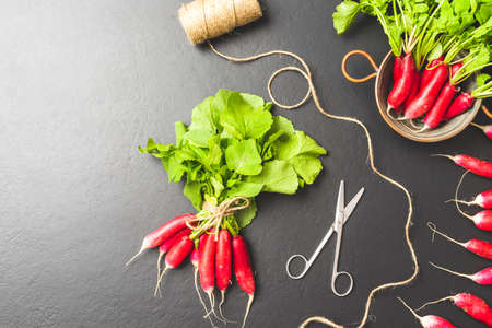 Fresh radishes on black background. Top view