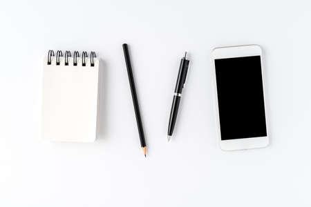 White background with phone and accessories. Office desktop