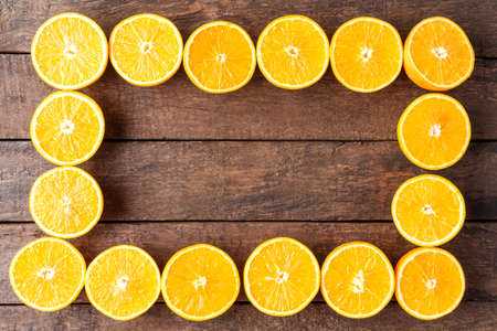 Fresh oranges on wooden backgroundの写真素材