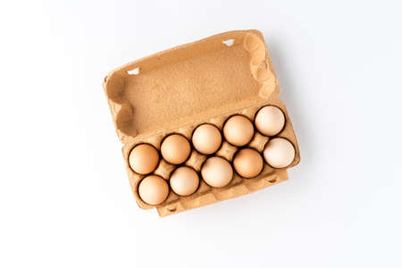 Fresh eggs in carton box isolated on white background. Top viewの写真素材