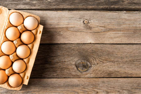 Fresh chicken eggs on wooden background with copyspaceの写真素材