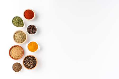 Overhead shot of seasonings in bowls isolated on white background with copyspaceの写真素材