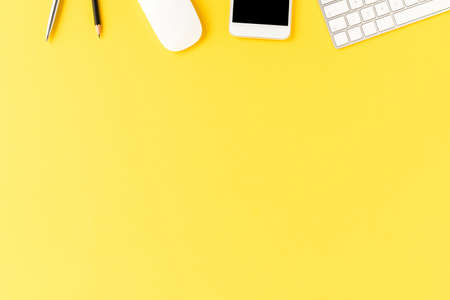 Office desktop with accessories on yellow table. Business background