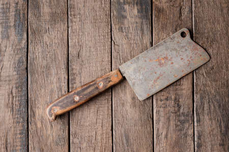 Vintage cleaver on wooden table. Top view