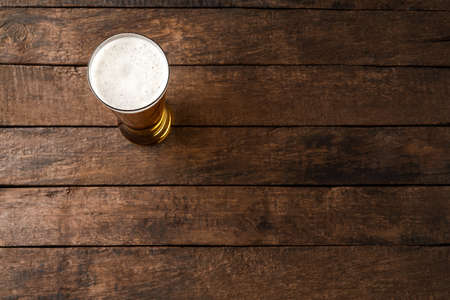 Beer glass on wooden table. Close upの写真素材