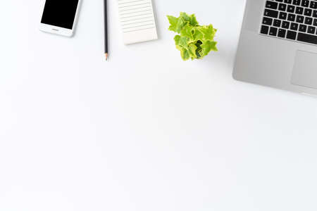 Overhead shot of modern workspace concept with laptop and business accessories on white background with copyspace. Office desktop. Flat layの写真素材