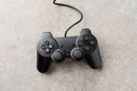 Black video game console on stone background. Top view. Close upの写真素材