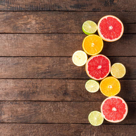 Overhead shot of juicy citruses on wooden tableの写真素材
