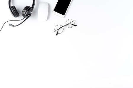 Helpdesk desktop with headset and accessories. Call center background with copyspace. Top viewの写真素材
