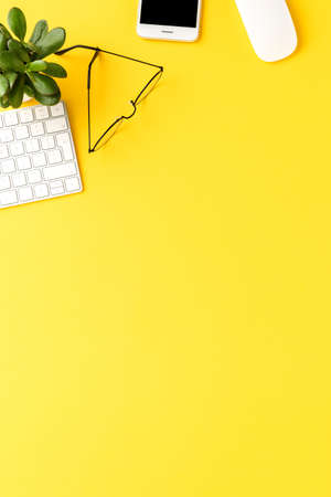 Elegant workspace with business accessories on yellow background with copyspace. Office desktopの写真素材
