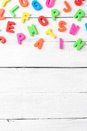 Colorful alphabet on white wooden background. Language school conceptの写真素材