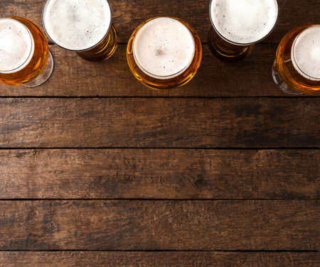 Beer glasses on wooden table with copyspace.の写真素材